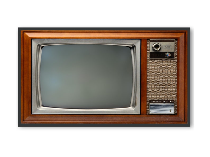 May include: A vintage television set with a wood frame and a black and white screen. The television has a silver control panel with a knob and a speaker grill.
