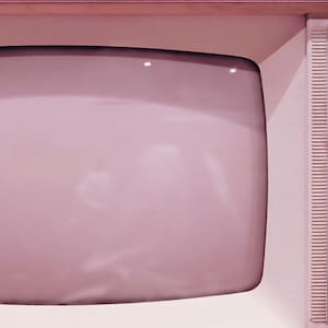 May include: A vintage television with a pink plastic casing and a black control panel with buttons labeled "UHF", "Lucalite", "AUS", "L/MF", "Ext. Ant", "Halligan", and "VHF".
