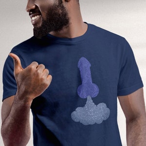 May include: A navy blue t-shirt with a blue and white graphic of a rocket ship.