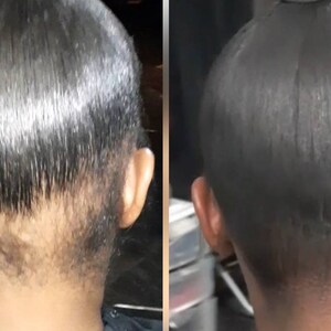 May include: A side view of a person's head with black hair pulled back into a ponytail. The hair is sleek and straight, with a visible part in the middle. The person's neck and shoulders are also visible.