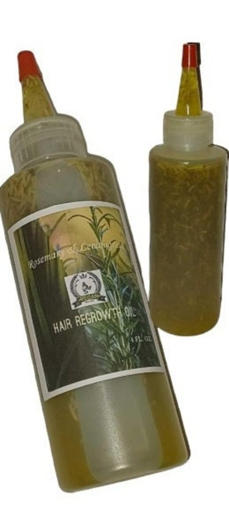 May include: Two clear glass bottles with red caps filled with a yellow liquid and herbs. The larger bottle has a label that reads "Rosemary & Lemongrass Hair Regrowth Oil 4 FL OZ".