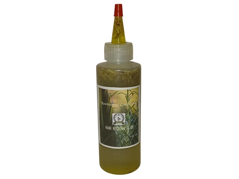 May include: A clear glass bottle with a red and yellow dropper top filled with a yellow liquid and herbs. The bottle label reads "Rosemary & Lemongrass Hair Regrowth Oil".