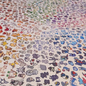 May include: A print featuring a multitude of cartoon creatures arranged in a gradient of colors. The creatures are in various poses and styles, creating a visually engaging and colorful display. The print is on a white background.
