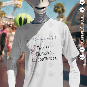 May include: White t-shirt with a humorous coding design. The text reads "foreach (var day in my life) { EAT(); SLEEP(); CODING(); }"