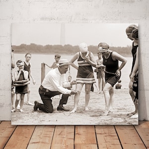 Beach policeman measuring the distance between a woman's knee and bathing suit, Washington DC, vintage beach fashion,history photo decor.