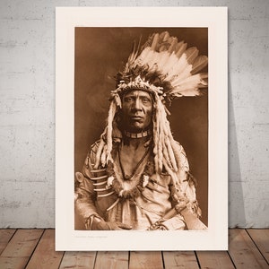Weasel Tail - Piegan by Edward Curtis, war-bonnet of eagle-feathers and weasel-skins, bone and grizzly-bear claw necklace, and tomahawk-pipe