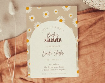 May include: A beige baby shower invitation with a white daisy pattern. The invitation features a white arch with the text "Join us for a Baby Shower" in brown text. The text "In honour of Emilie Clarks" is written in brown cursive. The date "06 | 03 | 22" is written in brown text. The time "At 4 o'clock" is written in brown text. The location "The dream house hotel 12 dream street Los Angeles" is written in brown text. The RSVP information "RSVP to emiliezlarks@gmail.com" is written in brown text.