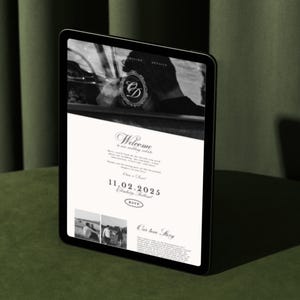 May include: A digital tablet displays a wedding website with a welcome message, date, and RSVP information. The website features a black and white color scheme with elegant typography and a monogram. The tablet is on a green surface.