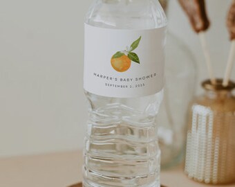 May include: A clear plastic water bottle with a white label that says "Harper's Baby Shower September 2, 2023" and features a watercolor illustration of an orange.