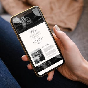 May include: A gold-framed smartphone displays a wedding invitation with a black and white design. The invitation includes the date, February 11, 2023, and the word "Welcome". The phone is held in a person's hand.