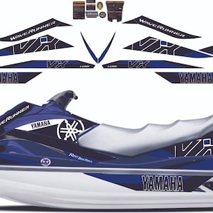 May include: A blue and white Yamaha WaveRunner VX personal watercraft with black and white graphics. The graphics include the Yamaha logo, WaveRunner, and VX.