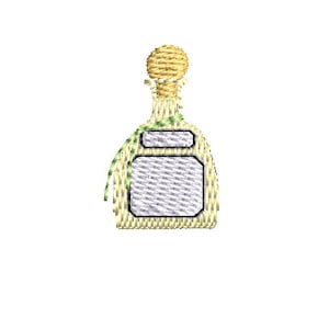 May include: A small, yellow glass bottle with a green ribbon and a white label. The bottle has a cork stopper.