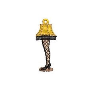 May include: A novelty lamp charm featuring a yellow lampshade with black trim and a fishnet-stocking clad leg. The lamp has a black high-heeled shoe and a gold loop for hanging. The lamp is a unique decorative item.
