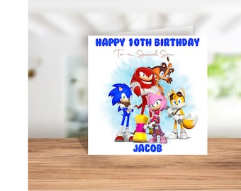May include: A birthday card featuring Sonic the Hedgehog, Tails, Knuckles, and Amy Rose. The card says "Happy 10th Birthday To a Special Son" and "Jacob".