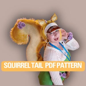 May include: A person in a squirrel tail costume with a visor. The costume features a large, fluffy tail, and the text "SQUIRREL TAIL PDF PATTERN" is displayed on a yellow banner. The visor says "DORE".