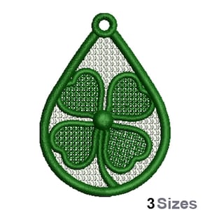 May include: Green four-leaf clover charm in a teardrop shape. The charm is outlined in green and has a white background.