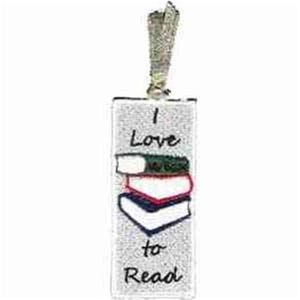 May include: A rectangular bookmark with the text "I Love to Read" and an illustration of three stacked books. The top book is green, the middle book is red, and the bottom book is blue. A silver ribbon is attached at the top.