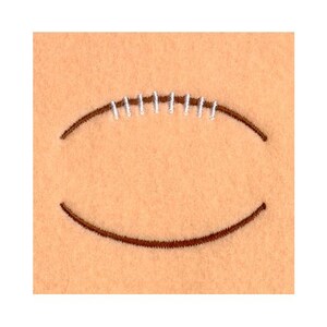 May include: Close-up of a tan felt football shape with brown stitching and white thread details. The football design is centered on a plain tan background.