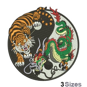 May include: A black and white yin yang symbol with a green and red dragon on one side and an orange and black tiger on the other side.