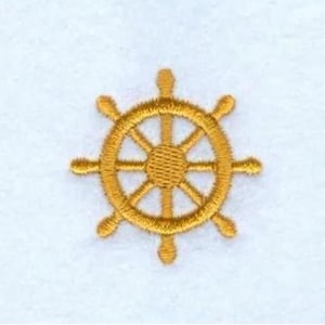 May include: Embroidered gold-colored ship's wheel. The wheel has eight spokes and a circular center. The design is stitched on a white background. The wheel is a nautical symbol.