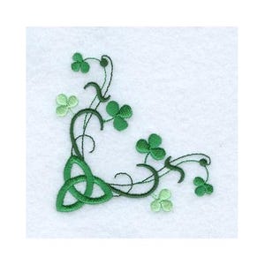 May include: Embroidered corner design featuring a green Celtic knot and shamrocks on a white background. The design includes a three-leaf clover and a Celtic knot, perfect for St. Patrick's Day or Irish-themed crafts.