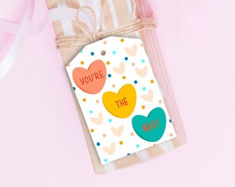 May include: A white gift tag with a colorful heart pattern. The tag has three hearts with the text "You're the best" on them.