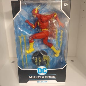 May include: A red and yellow action figure of The Flash from the DC Multiverse line. The figure is posed in a running position with lightning effects around it. The figure is packaged in a clear plastic box with a black and blue cardboard backing. The box has the DC Multiverse logo and the words "The Flash" printed on it.