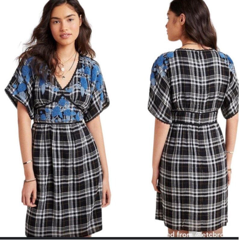 May include: A black and white plaid dress with blue floral embroidery on the sleeves and bodice. The dress has a V-neckline and a fitted waist. The sleeves are short and the skirt falls to the knees.