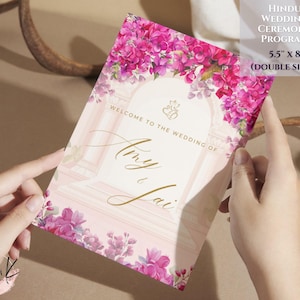 May include: A pink and white wedding ceremony program with floral accents. The program is 5.5 inches by 8 inches and is double-sided. The text on the front reads "Welcome to the Wedding of Amy & Jai".