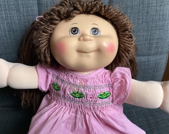 Retired 2000s OAA Cabbage Patch Kids Brown Yarn Haired Girl with Brown Eyes, Pretty Pink Smocked Dress
