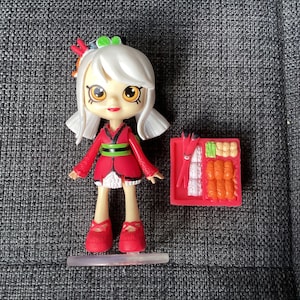 Retired Adorable Shopkins Lil Shoppies Happy Places Sara Sushi Mini Doll, with stand and sushi figures