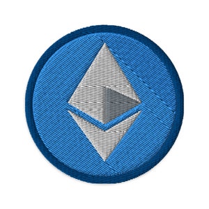 May include: Embroidered patch featuring the Ethereum logo. The design includes a white and gray Ethereum symbol set within a blue circle, with a darker blue border. The patch is likely for clothing or accessories.