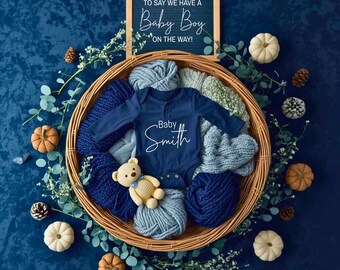 Navy & Blue Autumn Baby Reveal | Fall Baby Announcement Flat-Lay | Wicker Basket, Knits, Baby Onesie, Pumpkins and Eucalyptus Sprigs