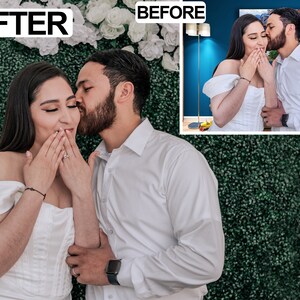 May include: A couple in formal attire, the woman in a white off-the-shoulder dress, the man in a white button-down shirt, embrace in front of a green hedge wall. The woman covers her mouth with her hands as the man kisses her cheek.
