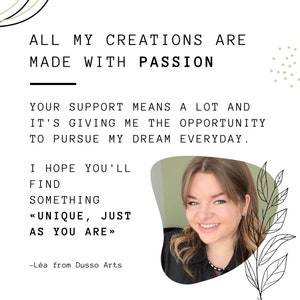 May include: A woman smiles at the camera in front of a green background with text that reads "All my creations are made with passion. Your support means a lot and it's giving me the opportunity to pursue my dream everyday. I hope you'll find something <<unique, just as you are>> -L&eacute;a from Dusso Arts"