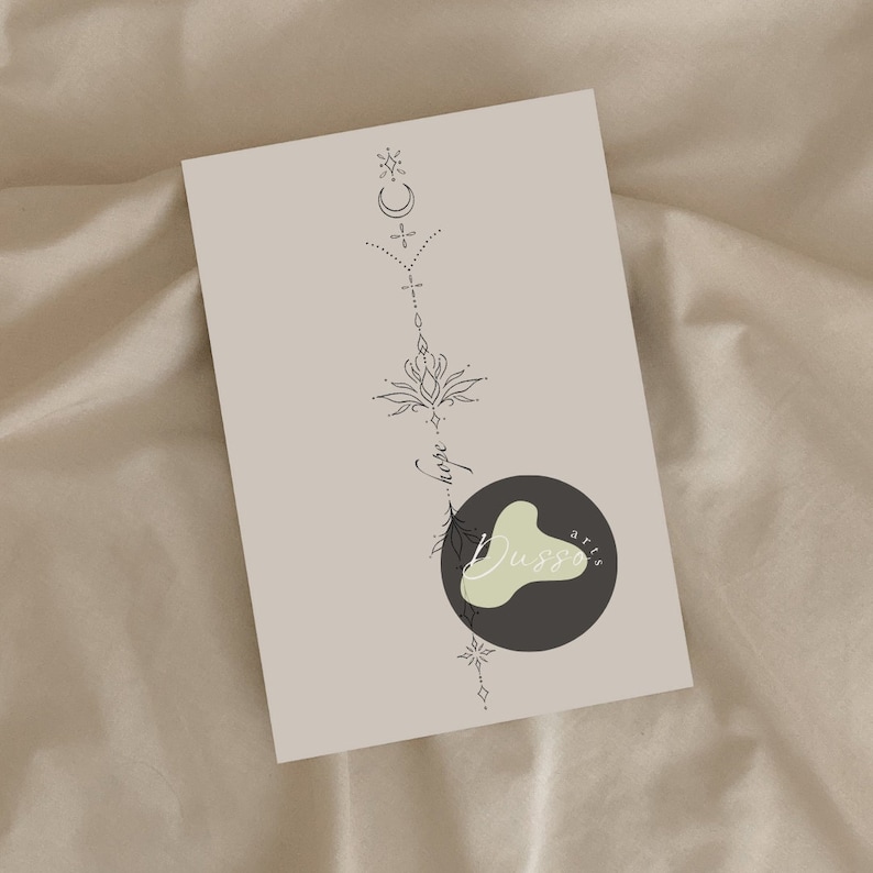 May include: A black and white line art design of a lotus flower with a crescent moon and stars above it. The design is on a beige background with the text "Hope" and "Dussa arts" below the flower.