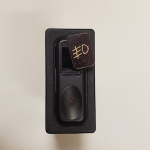 May include: Black plastic switch with a small brown label that says "#0" on it.