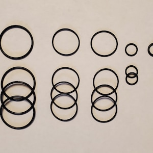 May include: A set of 11 black rubber o-rings of various sizes.