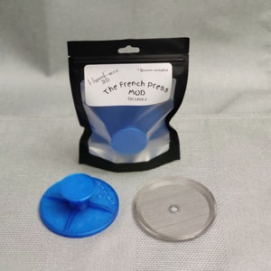 May include: A blue 3D printed French Press Mod for the Levo 2, with a silver mesh filter and a clear plastic bag labeled "The French Press Mod for Levo 2" and "HyperFocus 3D".