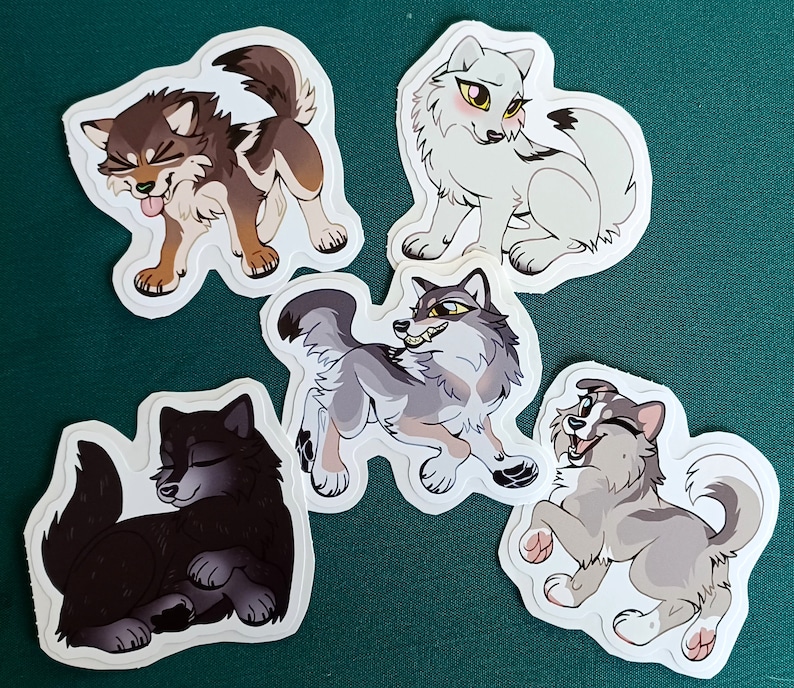 May include: Four colorful wolf stickers with different expressions. The stickers are on a green background.