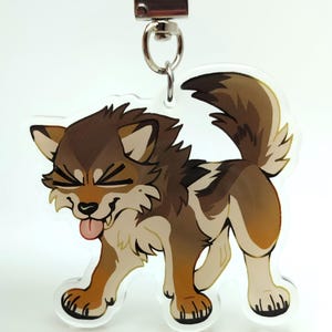 May include: A clear acrylic keychain featuring a cartoon wolf with brown and tan fur. The wolf is smiling with its tongue sticking out. The keychain has a silver-colored clasp.
