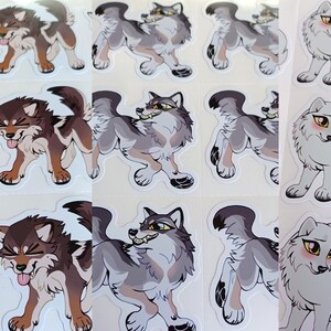 May include: A sheet of stickers featuring cartoon wolf illustrations. The wolves are in various poses, including standing, sitting, and walking. The stickers are printed on white paper and have a glossy finish.