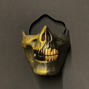 Maschera da zombi a mezzo teschio, oro e nero