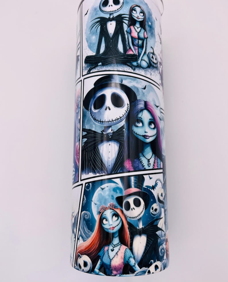 May include: A white tumbler with a colorful graphic print of Jack Skellington and Sally from the Nightmare Before Christmas. The print features multiple scenes of the couple in different poses.