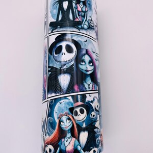 May include: A white stainless steel tumbler with a colorful graphic print of Jack Skellington and Sally from the Nightmare Before Christmas movie. The print features multiple scenes of the couple in different poses.