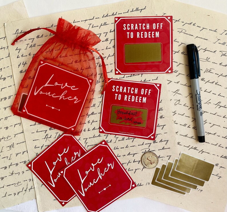 Red love coupons next to a red pouch and a black marker