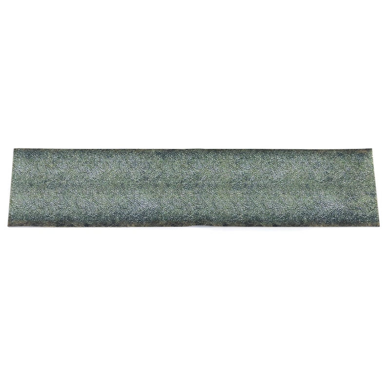 May include: A rectangular, textured sharpening stone with a mottled green and grey appearance. The stone is designed for sharpening tools and knives. The stone is approximately 20 cm long.