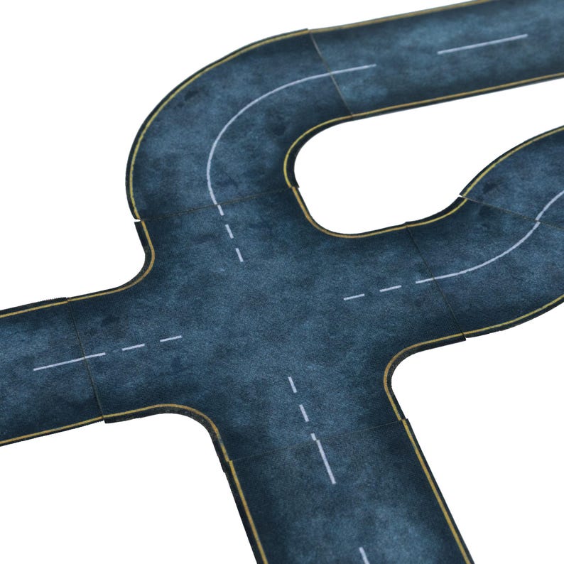 May include: A section of a toy road with a dark gray asphalt surface, white lane markings, and yellow edge lines. The road features curves and intersections, designed for toy cars and play sets.