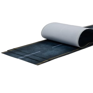 May include: A section of a miniature road with a dark gray asphalt surface, white lane markings, and yellow edge lines. The backing paper is partially peeled back, revealing the adhesive. The road is designed for model building or crafting.