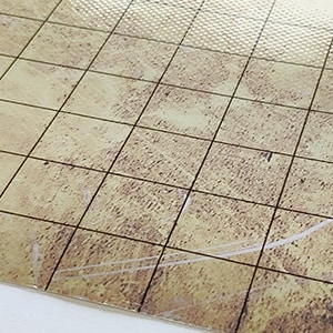 Puede incluir: Un tapete de juego beige y marr&oacute;n con un patr&oacute;n de cuadr&iacute;cula y una superficie texturizada. El tapete de juego tiene una cuadr&iacute;cula de l&iacute;neas negras y las palabras "PLAYMATS" y "LET'S PLAY TOGETHER" en naranja y blanco.